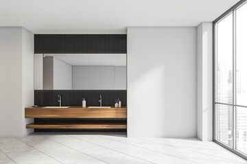 White bathroom with black tile and wood alike vanity area