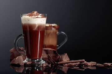 Poster - Hot chocolate with whipped cream and pieces of dark chocolate on a dark background.