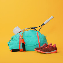 Blue Gym Bag And Sports Accessories On Yellow Background