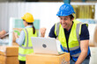 © offsuperphoto - engineer or factory worker using laptop computer, raised hand for celebrating joyful news
