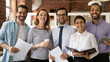 © fizkes - Team of diverse businesspeople multiethnic colleagues standing in modern office smile look at camera. Career advance, leadership, racial equality, professional company corporate staff portrait concept