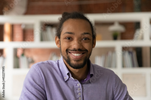 Head shot portrait African 30s man smile look at camera, profile picture of guy, webinar participant, stream video call event virtual meeting for business, fun, personal distance communication concept