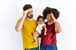 © Krakenimages.com - Interracial young family of black mother and hispanic father with daughter worried and stressed about a problem with hand on forehead, nervous and anxious for crisis