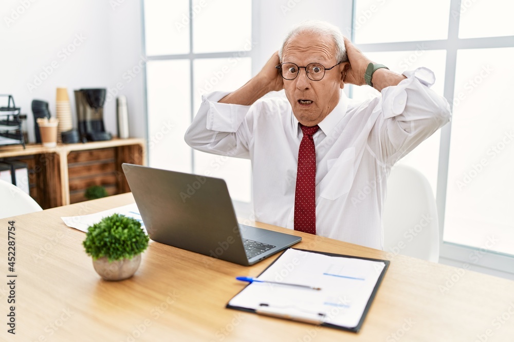 Scared Computer. Man Senior man working at the office using computer laptop crazy and scared ...