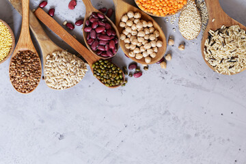 Wall Mural - various cereals in wooden spoons, healthy food