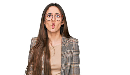 Canvas Print - Young hispanic girl wearing business clothes and glasses making fish face with lips, crazy and comical gesture. funny expression.