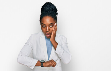 Poster - Young african american woman wearing business clothes looking at the watch time worried, afraid of getting late