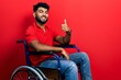 © Krakenimages.com - Arab man with beard sitting on wheelchair doing happy thumbs up gesture with hand. approving expression looking at the camera showing success.