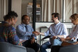 © fizkes - Smiling multiethnic colleagues shake hands get acquainted greet at group meeting in office. Happy diverse multiracial business partners handshake close deal at negotiation. Collaboration concept.