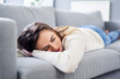 © baranq - Young woman taking nap sleeping on the sofa