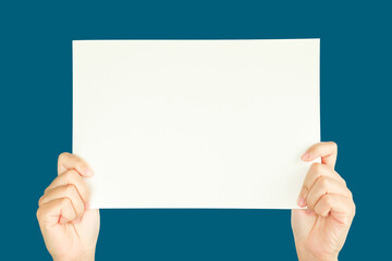 Sticker - women hand holding white blank paper isolated on blue background with clipping path