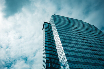 Wall Mural - high-rise skyscraper office building with dramatic cloudy sky