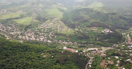 Wall Mural - Flying drone with a panoramic view of the famous resort town of Dilijan in Armenia surrounded by dense forests and the Caucasus mountains