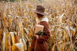 Style woman with gift box on corn field in autumn time season