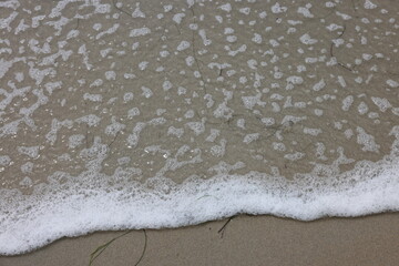 Wall Mural - Wave Foam, bottle on the beach 