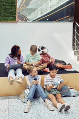 Wall Mural - Vertical full length portrait of multi-ethnic group of children in modern school interior, copy space