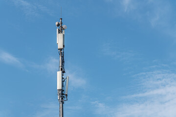 communications tower against blue cloudy sky