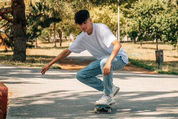 Poster - teenage boy with skateboard on the street