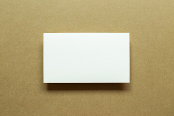 White blank memo paper on brown background. top view, copy space