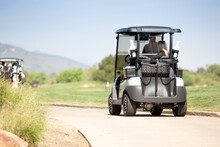 A View Of A Golf Cart On The Trail To The Next Golf Course Hole.