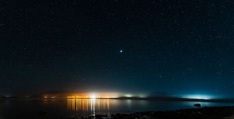 Wall Mural - night view to small town at Mount Waddington many stars on dark sky.