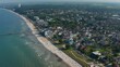 Baltic sea coastline in Scharbeutz, Germany. Aerial drone flying above tourist sea summertime beach, dolly in, day