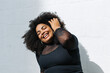 © (JLco) Julia Amaral - Pretty plus size woman against white wall