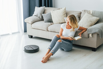 Wall Mural - Woman in casual clothes is indoors at home