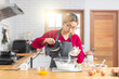 © peerasin - Asian girl using the blender, blend dough and other ingredients for cooking the chocolate cake with happy feeling in the kitchen room.