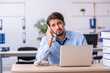 © Elnur - Young male employee and too much work in the office