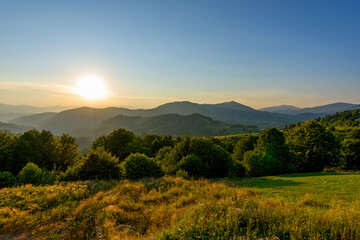 Wall Mural - Amazing mountain landscape with colorful vivid sunset on the cloudy sky