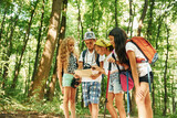 Fototapeta  - Summertime weekend. Kids strolling in the forest with travel equipment