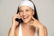 © vladimirfloyd - young smiling woman without makeup with headband talking on the phone