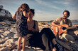 © astrosystem - Family on a vacation, singing, playing music on a guitar and enjoying summertime vibes.
