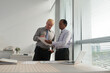 © DragonImages - Businessman discussing document with new order of company CEO with colleague