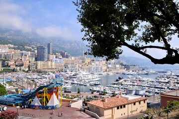 Wall Mural - Monte Carlo harbor in Monaco. Port Hercules. Yachts in the port. Aerial view, cityscape. Water slides are installed in the port. Outdoor aquapark.