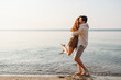 © ViDi Studio - Side view happy smiling young couple two friends family man woman in white clothes hug boyfriend hold girl rest together at sunrise over sea beach ocean outdoor seaside in summer day sunset evening
