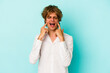 © Asier - Young caucasian man with make up isolated on blue background  crying, unhappy with something, agony and confusion concept.