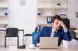 © Elnur - Young male employee and too much work in the office