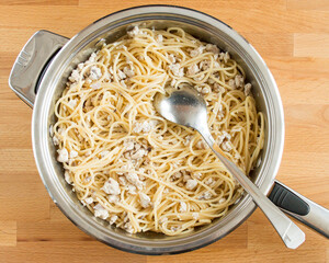 Spaghetti with minced chicken in a pan. Top view, there is no one