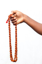 Selective Focus Of A Chanting Hand With Rudraksha Beads.