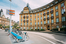 LUXEMBOURG. Row Of City Bikes For Rent On A Background Of Bank Building
