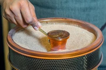 Canvas Print - Closeup shot of a Turkish coffee sand machine with a jar