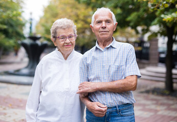 mature couple of man with a woman strolling outdoor in park