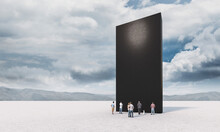 People Standing In Front Of A Black Monolith