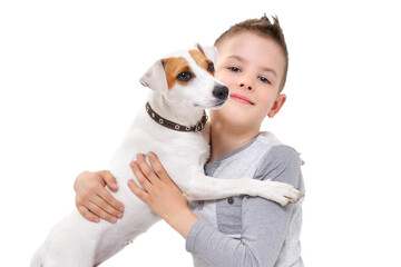 Portrait of a boy hugging his dog Parson Russell Terrier isolated on white background