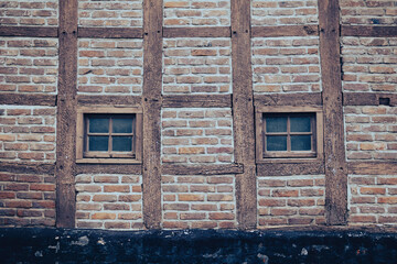 Detail of an old Limburg half-timbered house with 2 windows in the masonry outer wall.