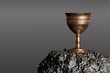 Old chalice over the stone and grey background. 3D Render