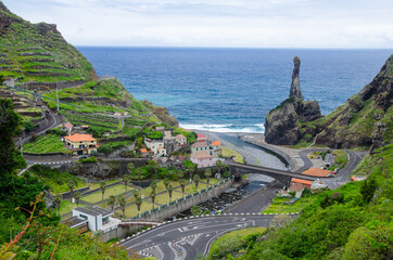 View of a small urban area with ocean and rocks in the background. Ribeira da Janela, Madeira.