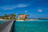 Fototapeta Na sufit - hard rock hotel buildings with palms against the background of emerald water. Crossroads Maldives, july 2021